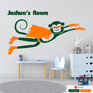 
            
                Load image into Gallery viewer, Cheeky monkey superhero flying wall decal with space for personalised name of your choice in forest green and orange
            
        